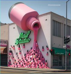 a giant pink paint can is pouring liquid onto the side of a nail studio building