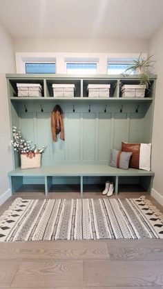 a room with a bench and rug on the floor