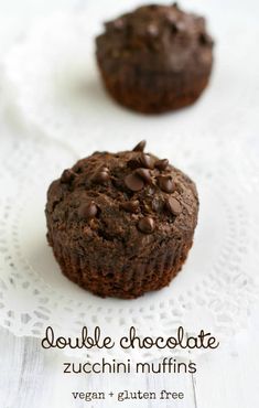 double chocolate zucchini muffins on a white doily with text overlay