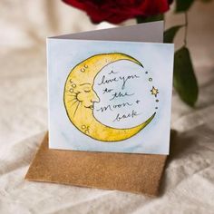 a card with a drawing of a crescent moon on it