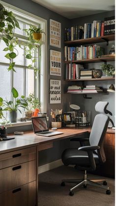 a desk with a laptop computer sitting on top of it next to a book shelf filled with books