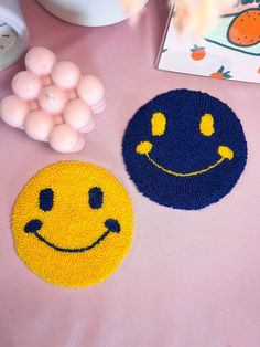 two smiley face rugs sitting on top of a table