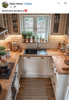 a kitchen with white cabinets and wooden counter tops is featured in the instagram post