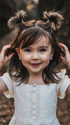 This adorable style involves creating two small buns at the top of the head, adding a modern twist with frosted tips for a cool 2024 look. The buns are playful and perfect for active toddlers who need their hair out of the way, yet still want to look cute. It works best for toddlers with medium to long hair, and the frosted tips can add dimension to darker hair colors. Haircut For Toddler Girl, Girl Toddler Haircut, Girls First Haircut, Short Hair For Toddler Girl, Kid Girl Haircut, Toddler Girl Haircuts, Flower Girl Hair Toddler