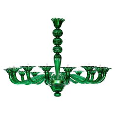 a green glass chandelier with six lights on each side and four candles in the middle