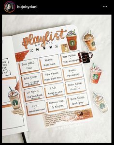 an open planner with coffee and drinks on it, next to other items that include magnets