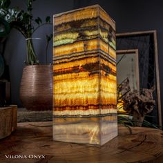 a vase sitting on top of a wooden table