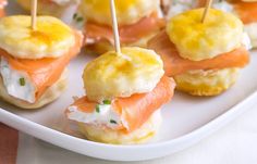 small appetizers are arranged on a plate with toothpicks sticking out of them