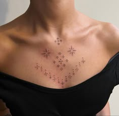 a woman's chest with small stars on it