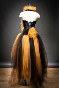 a mannequin dressed in black and yellow tulle