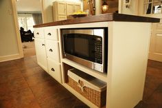 a microwave oven sitting on top of a wooden counter