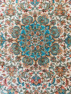 an intricately designed carpet with blue and red colors