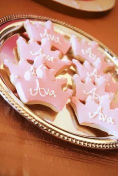 some pink cookies are on a silver platter with the words i love you written on them