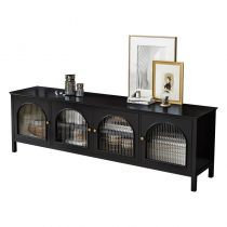 a black entertainment center with glass doors and metal mesh baskets on the bottom shelf, along with framed pictures