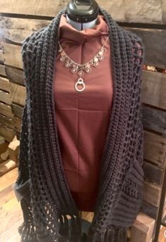 a mannequin wearing a sweater and necklace