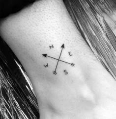 an arrow tattoo on the ankle