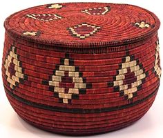 a woven basket is shown on a white surface with red, black and tan designs