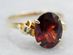 This ring features a simple and classically designed mounting, the structural openwork shoulders lend a sense of light and grace to the mounting. Cut into a classic oval cut, the deep red cherry garnet in the center adds a lovely pop of color and also an interesting shape to a simple ring!Metal: 14K Yellow Gold Gem: Pyrope Garnet 2.81 CaratsGem Measurements: 7.9 x 10.0 mm, Oval Ring Size: 6.75Marks: “R/585” Stamped on the inside band Elegant Oval Garnet Birthstone Ring, Heirloom Garnet Oval Birthstone Ring, Ruby Solitaire Ring, Aquamarine Solitaire Ring, Garnet Ring Vintage, Pyrope Garnet, Sapphire Solitaire Ring, Unique Engagement, Garnet And Gold