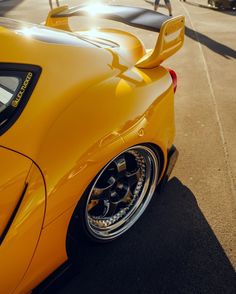 the rear end of a yellow sports car