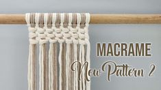 the macrame new pattern 2 is hanging from a wooden pole with yarn on it