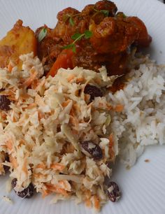 a white plate topped with rice and meat