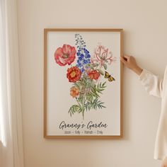 a woman standing in front of a painting with flowers on it and a butterfly flying by