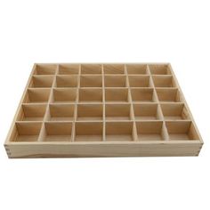 a wooden tray with compartments for various items on it, and one section is empty