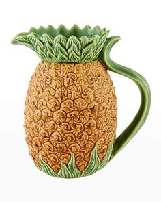 a ceramic pineapple mug with green leaves on it