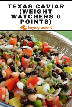 a bowl filled with beans and veggies on top of a table