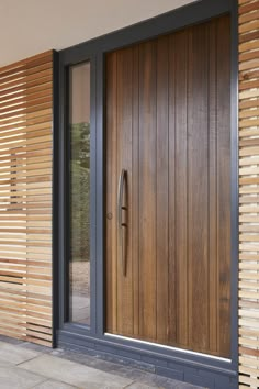 a wooden door is shown in front of a building