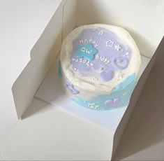 a blue and white birthday cake in a box