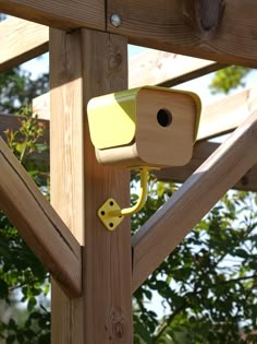 a wooden structure with a yellow camera attached to it