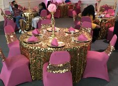 a banquet room with pink and gold table cloths