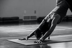 a person doing a handstand on a yoga mat