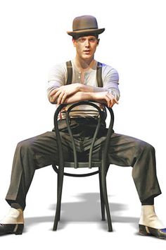 a man sitting on top of a metal chair