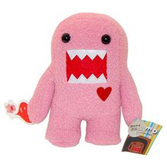 a pink monster stuffed animal with big eyes and mouth wide open holding a candy bar