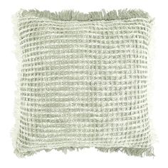 a white pillow with fringes on the front and back of it, against a white background