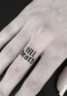 a person's hand with a small tattoo on it