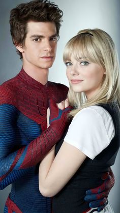 the amazing spider - man and woman are posing together