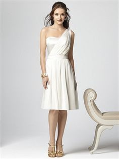 a woman in a white dress standing next to a bench with her hands on her hips