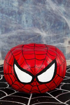 a close up of a spiderman ball on a surface