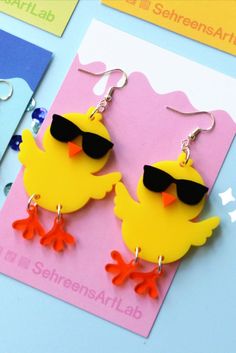 Cool chick earrings are new at my shop! These are always such a conversation starter and a statement piece for sure! #earrings #earrings for her #earrings handmade #acrylic earrings #chicken owner #gift #chicken #hen #animal art #animal jewelry #animal earrings #cool chick #funny #cute #kawaii #kawaii fashion #earring making #earring ideas #earring love #earring design #cute earrings #dangle earrings #big earrings#large jewelry #statement earrings #statement jewelry #yellow #chick #farm animals Earrings Cool, Chicken Owner, Easter Jewelry, Easter Earrings, Chicken Hen, Crafting Jewelry, New Business Ideas, Earrings Big, Hens And Chicks