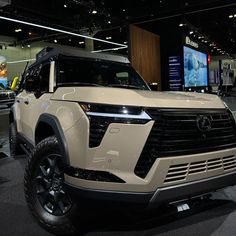 a white suv is on display at an auto show