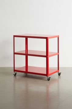 a red shelf sitting on top of a white floor