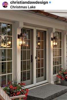 an image of a front porch with flowers and potted plants