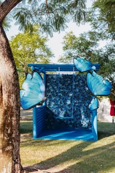 a blue sculpture in the middle of a park