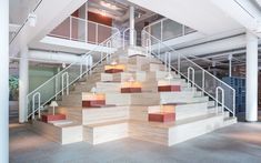 the stairs are made out of wood and have red blocks on each side, along with white railings