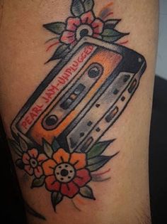 a tattoo with an old school cassette on it