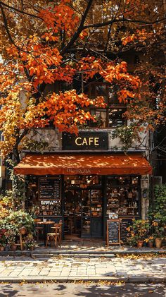 the cafe is surrounded by autumn foliage and trees with orange leaves on it's branches