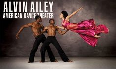 two dancers in red and black clothing are posing for the camera with their arms around each other